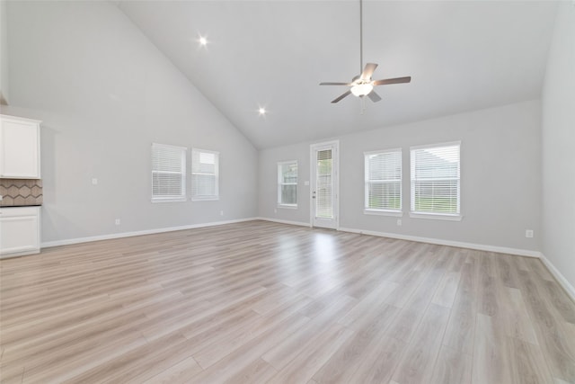 unfurnished living room featuring baseboards, a ceiling fan, high vaulted ceiling, and light wood-style flooring