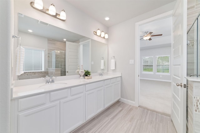 full bathroom with a sink, a ceiling fan, baseboards, visible vents, and a stall shower