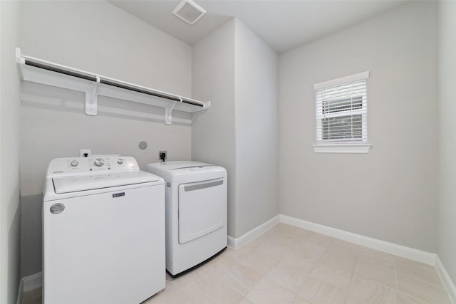 laundry room featuring washer and dryer, laundry area, visible vents, and baseboards