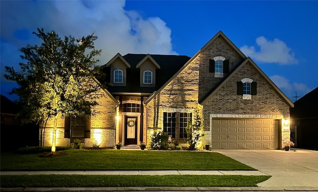view of front facade with concrete driveway, brick siding, a garage, and a front lawn