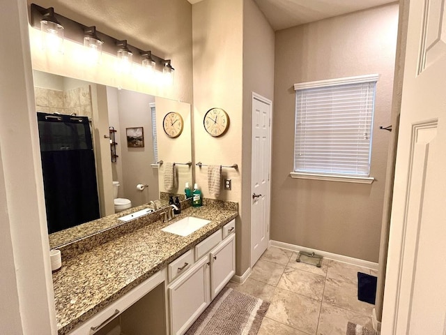 full bathroom with a shower with curtain, vanity, baseboards, toilet, and marble finish floor
