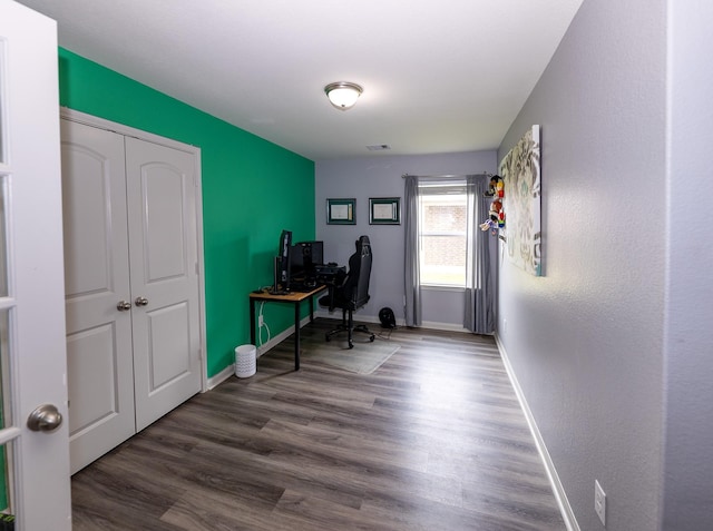 office with baseboards, wood finished floors, and visible vents