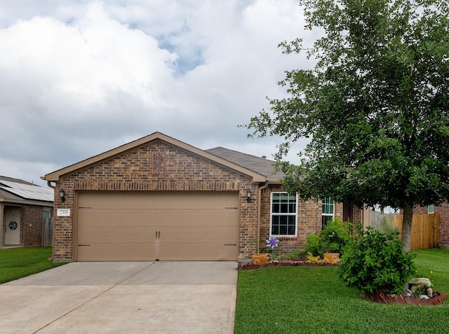 ranch-style home featuring brick siding, an attached garage, a front yard, and concrete driveway