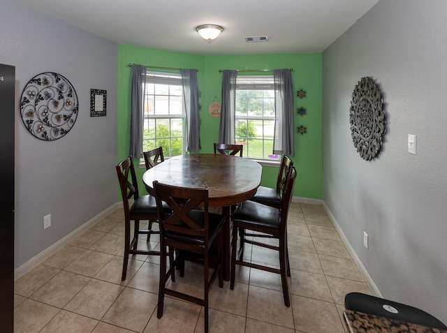 dining room with light tile patterned floors, baseboards, and visible vents