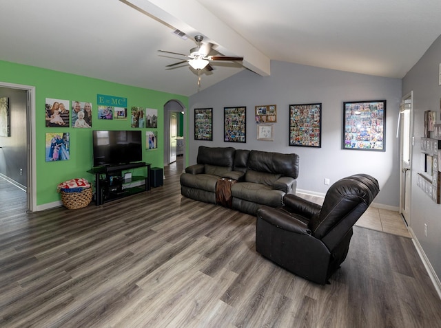 living room with a ceiling fan, arched walkways, wood finished floors, baseboards, and lofted ceiling with beams