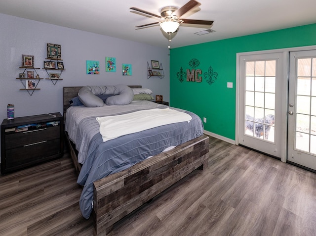 bedroom featuring visible vents, wood finished floors, access to exterior, baseboards, and a ceiling fan