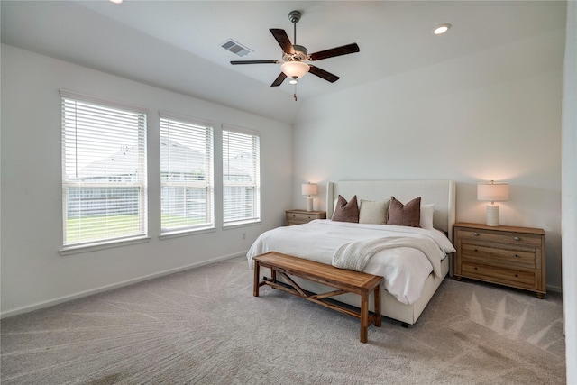 bedroom featuring visible vents, baseboards, and light carpet