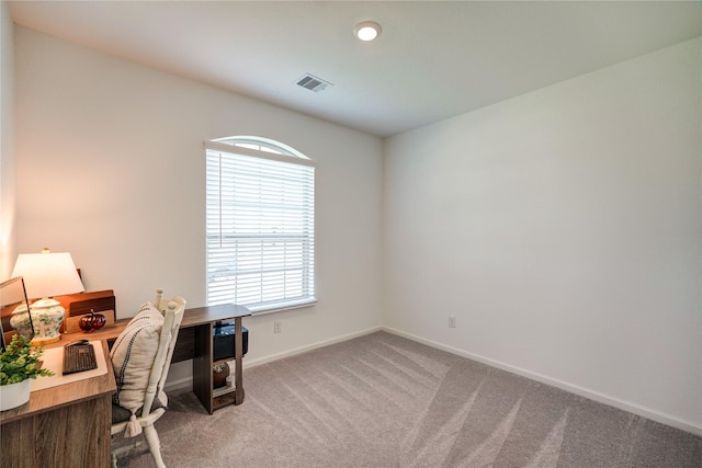 office space with baseboards, visible vents, and carpet
