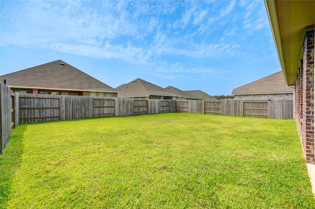view of yard with a fenced backyard