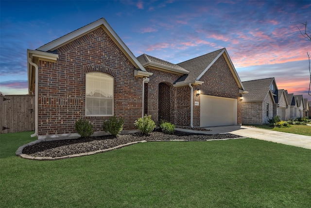 view of front of house featuring driveway, brick siding, fence, a front lawn, and an attached garage