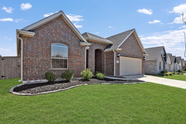 view of front of house featuring fence, an attached garage, a front lawn, brick siding, and driveway