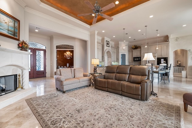 392 Green Cove Dr, Montgomery, TX 77356 - living room with crown molding, a raised ceiling, ceiling fan with notable chandelier, recessed lighting, and a premium fireplace