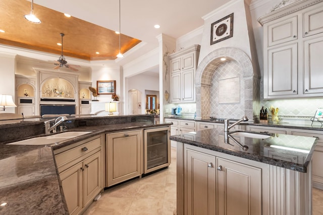 392 Green Cove Dr, Montgomery, TX 77356 - kitchen featuring a sink, wine cooler, open floor plan, and tasteful backsplash