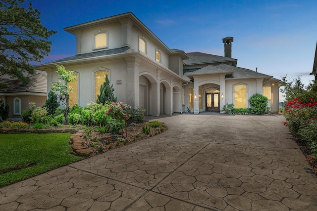 392 Green Cove Dr, Montgomery, TX 77356 - mediterranean / spanish house featuring a chimney, stucco siding, french doors, and driveway