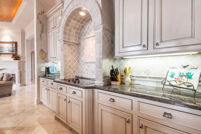 392 Green Cove Dr, Montgomery, TX 77356 - kitchen with crown molding, black electric cooktop, tasteful backsplash, and cream cabinetry