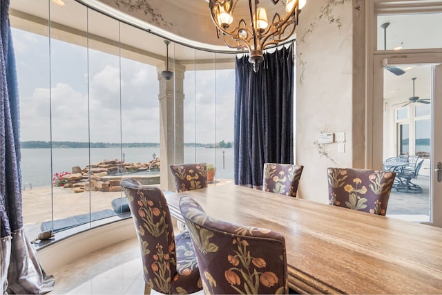 392 Green Cove Dr, Montgomery, TX 77356 - dining room with a water view, ceiling fan with notable chandelier, and a wealth of natural light
