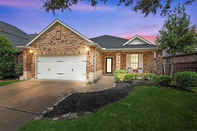 single story home with brick siding, a garage, fence, and concrete driveway