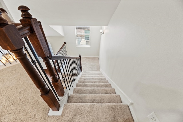 stairway with carpet floors and baseboards