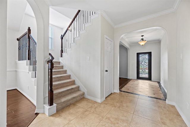 entryway with arched walkways, plenty of natural light, and baseboards