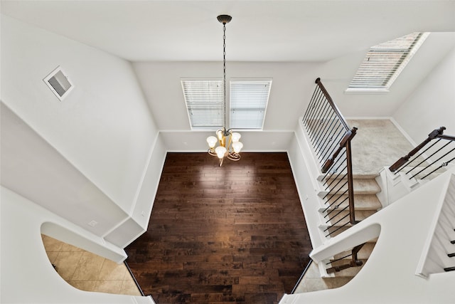 unfurnished dining area featuring visible vents, baseboards, a notable chandelier, and a healthy amount of sunlight