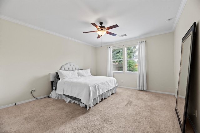carpeted bedroom featuring baseboards, ornamental molding, ceiling fan, and visible vents