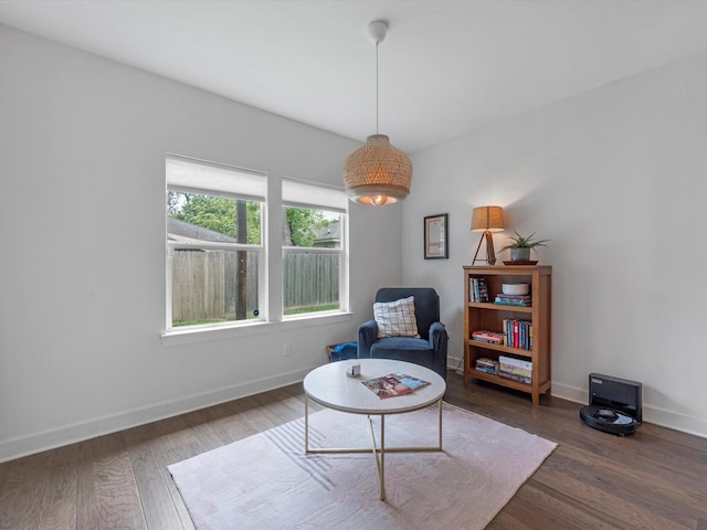 sitting room featuring baseboards and wood finished floors