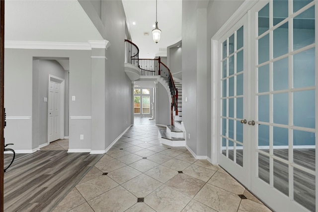 entryway featuring stairs, baseboards, and french doors