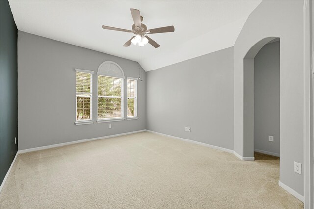 unfurnished room featuring carpet flooring, ceiling fan, baseboards, and lofted ceiling