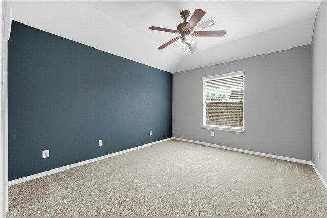 unfurnished room with vaulted ceiling, baseboards, a ceiling fan, and carpet flooring