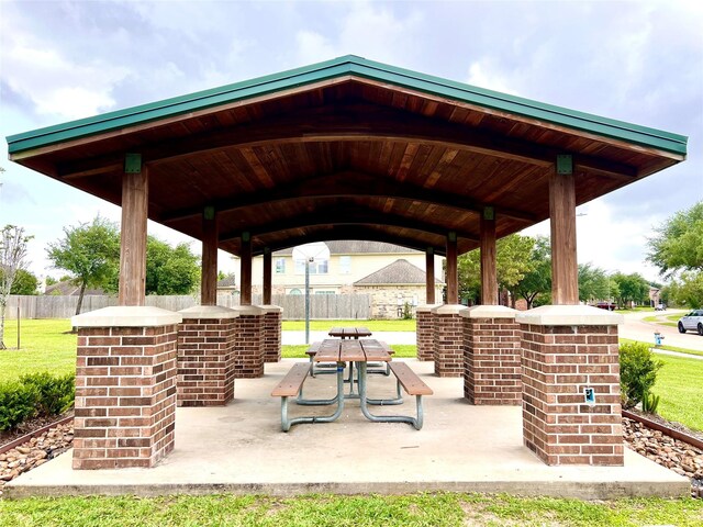 view of property's community featuring a gazebo, a patio area, fence, and a yard