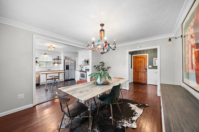 dining area featuring an inviting chandelier, a textured ceiling, crown molding, and dark wood finished floors