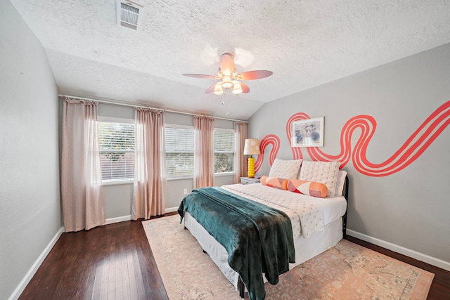 bedroom featuring a ceiling fan, a textured ceiling, visible vents, baseboards, and wood-type flooring