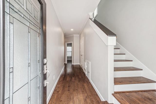 hallway featuring recessed lighting, baseboards, wood finished floors, ornamental molding, and stairway
