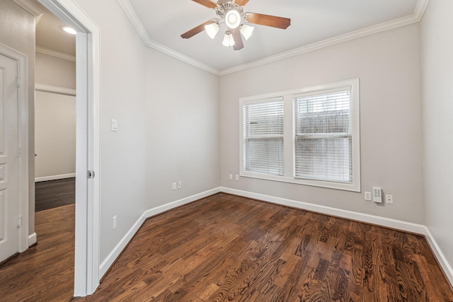 spare room featuring crown molding, baseboards, ceiling fan, and dark wood-style flooring
