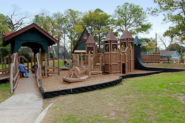 community jungle gym with fence and a yard