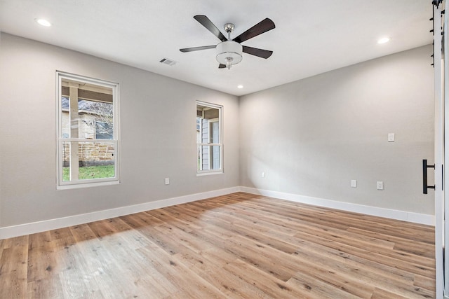empty room with light wood finished floors, a ceiling fan, baseboards, recessed lighting, and visible vents