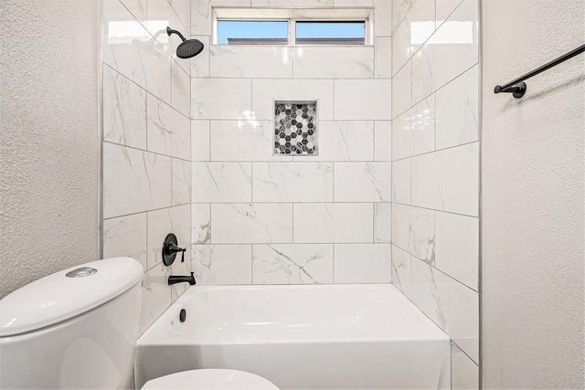 full bath featuring  shower combination, a textured wall, and toilet