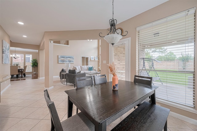dining area with baseboards, recessed lighting, a notable chandelier, and light tile patterned flooring