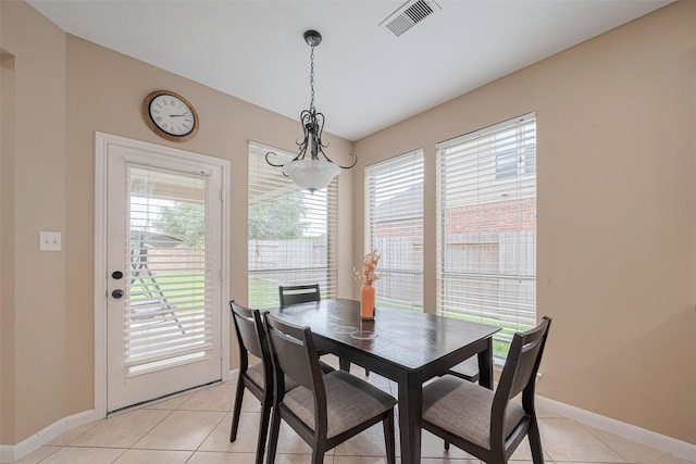 dining area featuring baseboards, visible vents, and light tile patterned floors