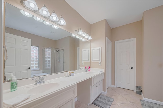 bathroom with tile patterned flooring, a sink, a stall shower, and double vanity