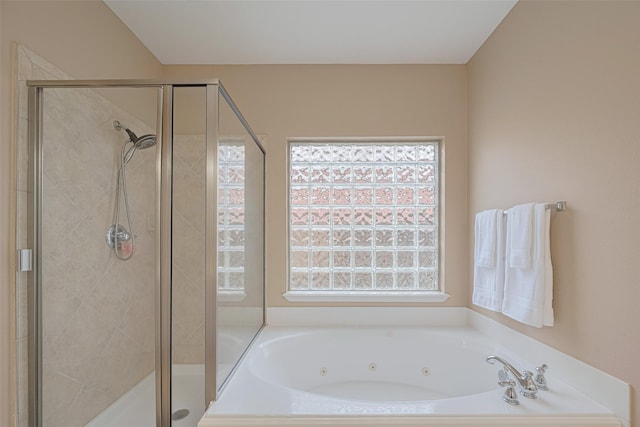 full bathroom with a whirlpool tub and a stall shower