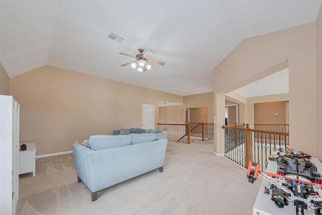 living room with visible vents, ceiling fan, lofted ceiling, and light carpet