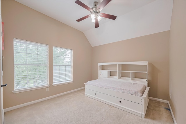 carpeted bedroom featuring baseboards, a ceiling fan, and vaulted ceiling