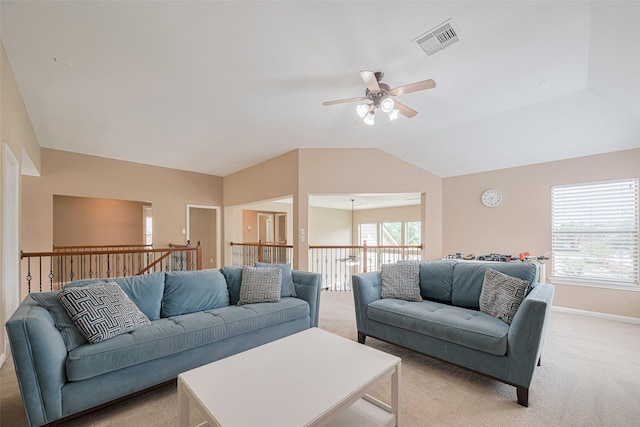 living area with visible vents, lofted ceiling, light carpet, baseboards, and a ceiling fan