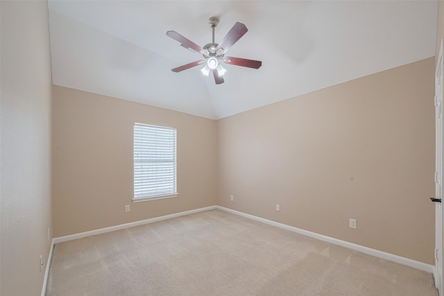 empty room featuring baseboards, a ceiling fan, lofted ceiling, and light colored carpet