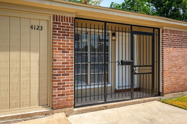 doorway to property with brick siding