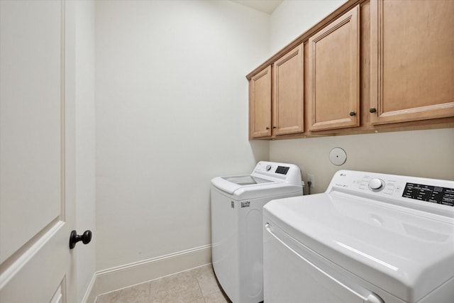 27018 Camirillo Creek Ln, Katy, TX 77494 - laundry room featuring washing machine and clothes dryer, light tile patterned flooring, baseboards, and cabinet space