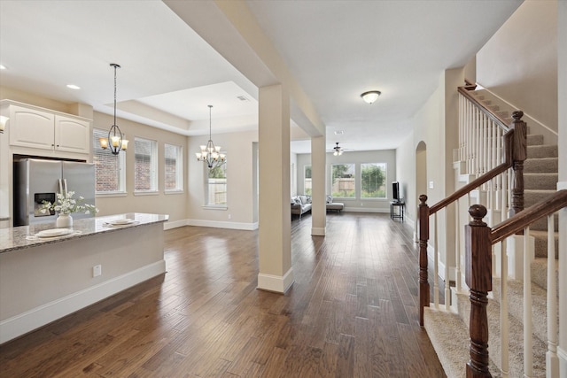 27018 Camirillo Creek Ln, Katy, TX 77494 - entrance foyer featuring dark wood-style flooring, arched walkways, stairway, baseboards, and a raised ceiling