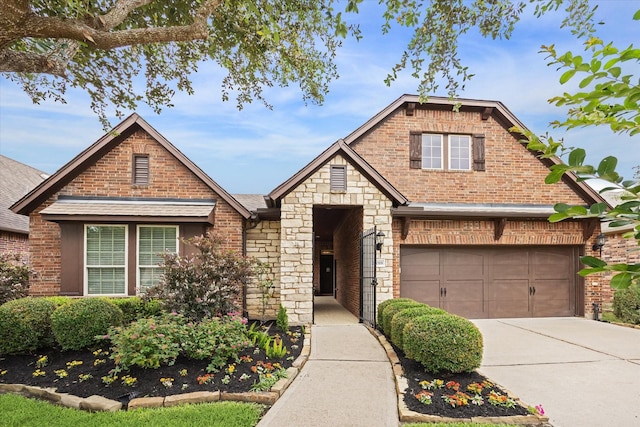 27018 Camirillo Creek Ln, Katy, TX 77494 - view of front of home with brick siding, driveway, stone siding, and roof with shingles