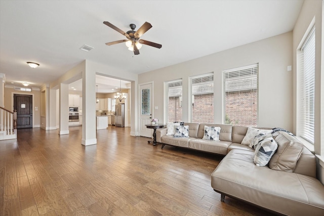 27018 Camirillo Creek Ln, Katy, TX 77494 - living room with visible vents, dark wood finished floors, ceiling fan with notable chandelier, and baseboards